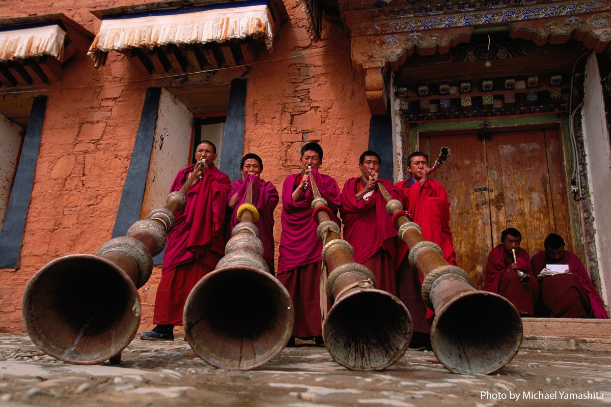 Labrang Monastery, novice monks (trapa), practice blowing the dungchen, traditional 13-foot horns, that will be used in Buddhist ceremonies and call to prayer. The sound can be compared to the singing of elephants.
